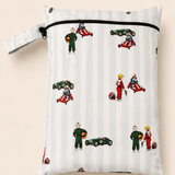 A rectangle PUL fabric daycare wet bag  with a zipper closure and a button loop strap, printed with a hand vintage racing pattern on a light grey and white stripe background. The print includes a boy in a vintage go kart, boy in a green race suit and a vintage race car. Photographed on a soft a beige background.