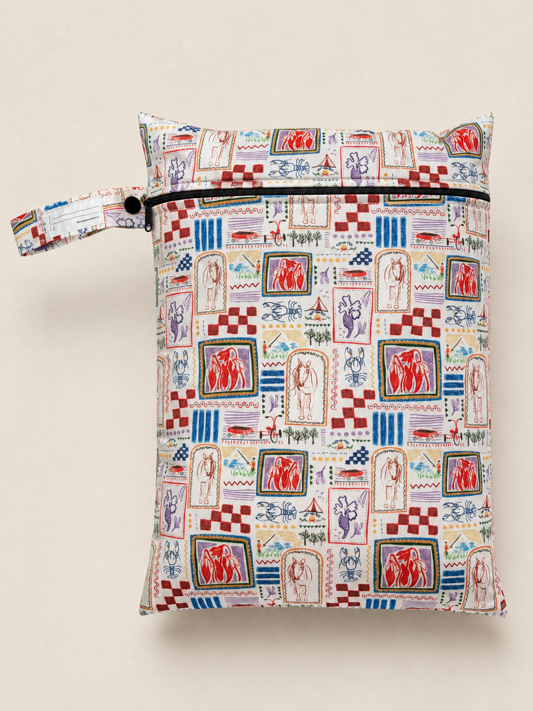 A zippered daycare wet bag with a colourful hand drawn vintage-style illustrated print. A repeating pattern of different abstract drawings with horses, person fishing, campfire, vintage bike with trailer, scorpion and various trees, plants and florals. It features a matching fabric loop strap with a black snap button, set against a solid light beige background.